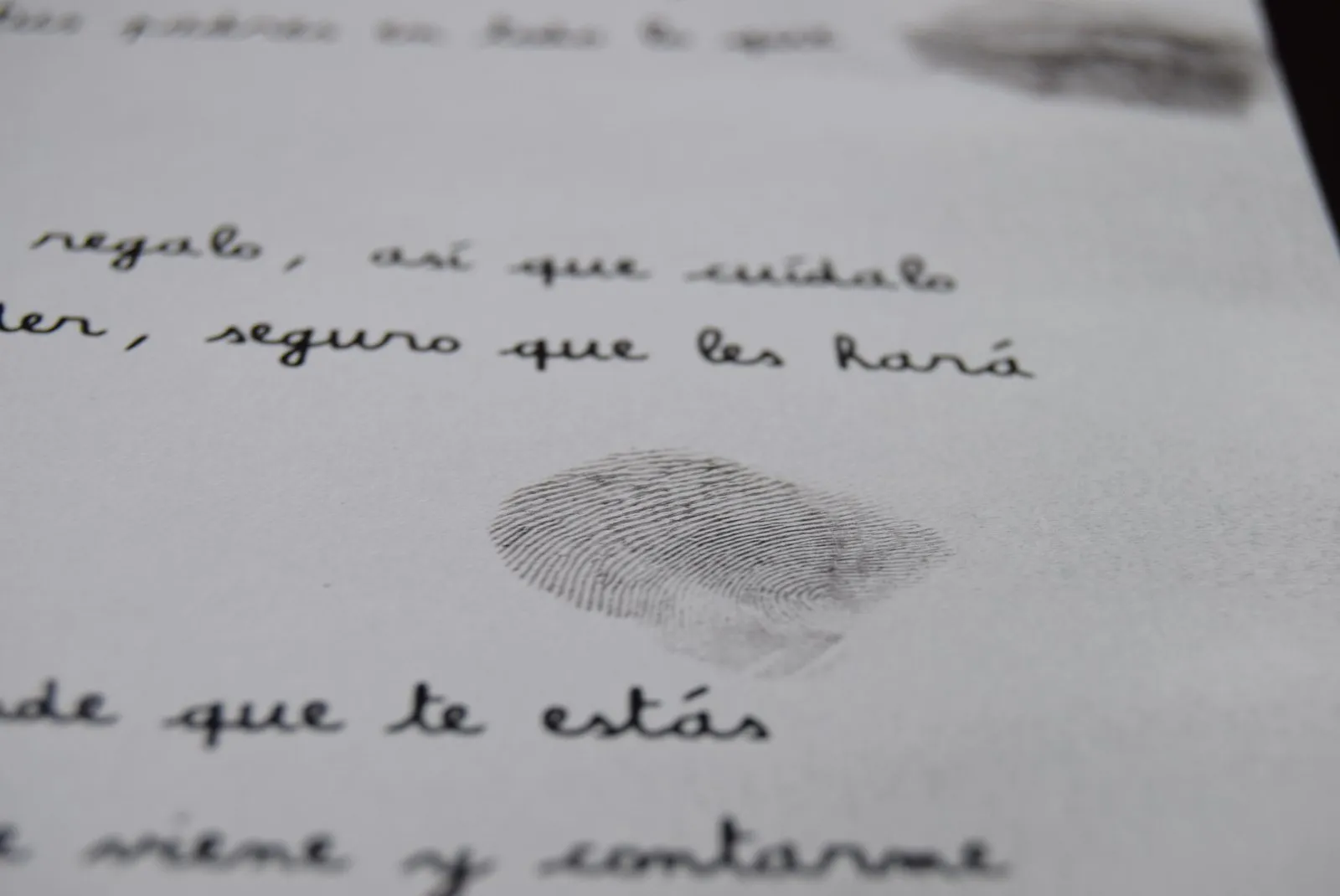 Primer plano de una huella dactilar de carbón sobre la carta de Olentzero